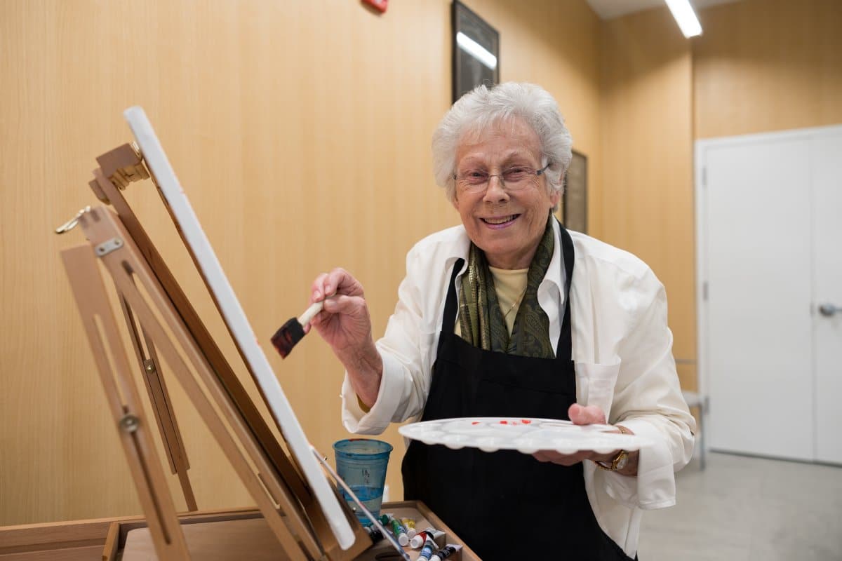 The Cordwainer | Senior woman smiling and painting