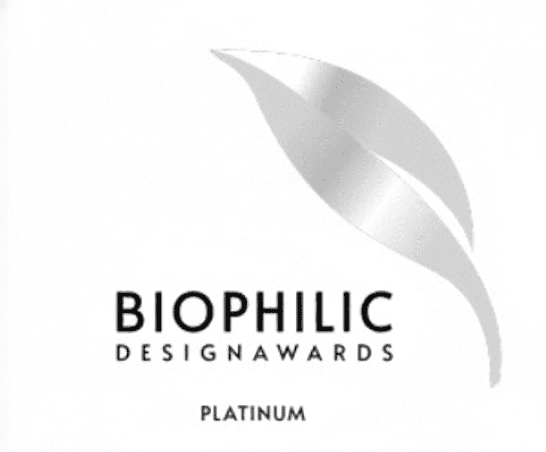 A silver, stylized leaf logo above the words BIOPHILIC DESIGN AWARDS in black text, with PLATINUM written below on a white background.