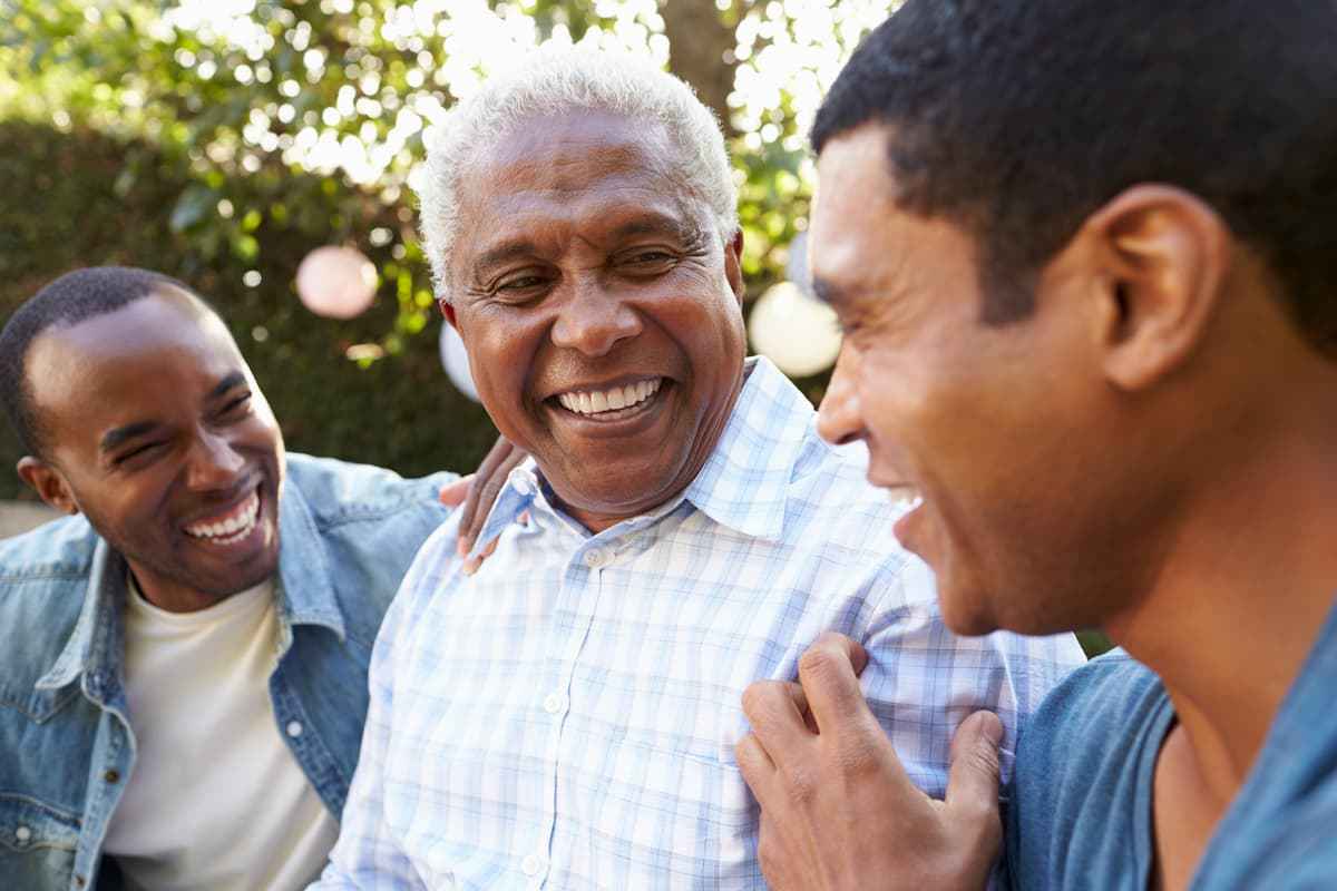 Cordwainer Memory Care | Senior man laughing with his sons