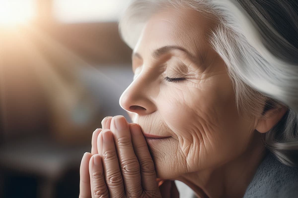 The Cordwainer Memory Care | Senior Woman Praying Reflecting In The Light