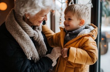 The Cordwainer | Senior woman putting a coat on her grandchild