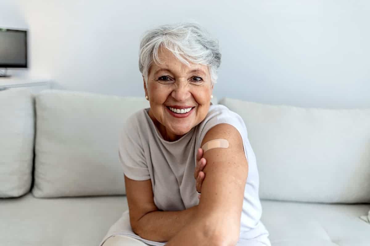 Cordwainer Memory Care | Senior Showing Her Vaccine Bandage